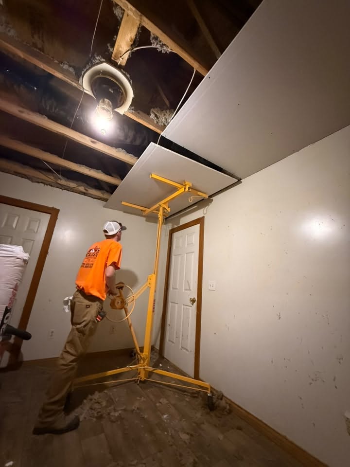 McAllister Construction crew member installing drywall during a home remodel